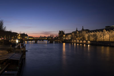 Bridge over river against sky at sunset