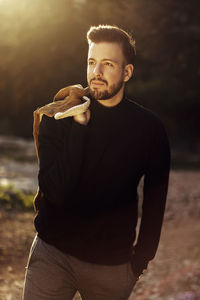Portrait of young man standing outdoors