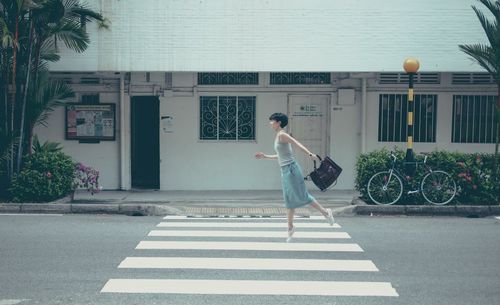 Full length of man on street against buildings in city