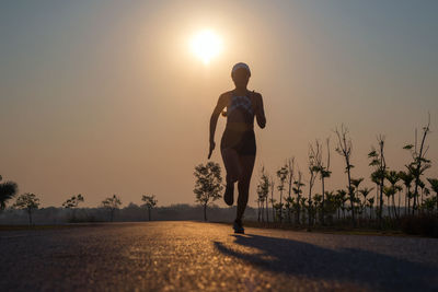 Full length of woman running on road