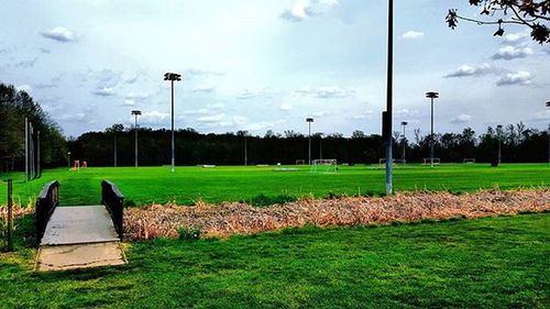 Scenic view of grassy field against cloudy sky