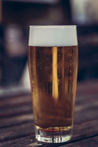 Close-up of beer glass on table