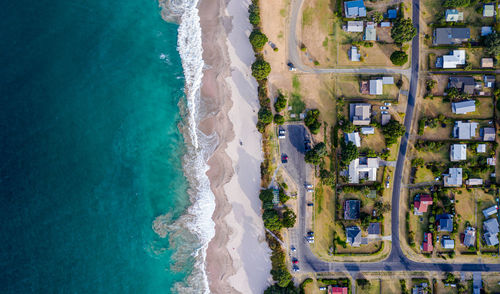 High angle view of sea and buildings in city