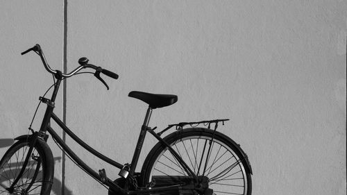 Bicycle leaning against wall