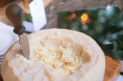 High angle view of cheese with knife on table