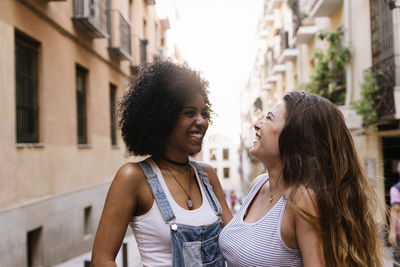 Smiling young woman standing in city