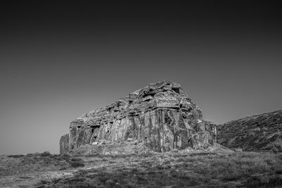 Low angle view of rock formation against clear sky