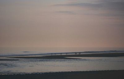 Scenic view of beach against sky during sunset