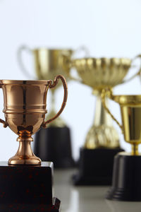 Close-up of trophies against white background