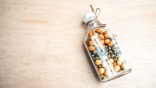 Directly above shot of food in bottle on wooden table