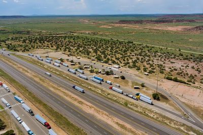 High angle view of road amidst field against sky