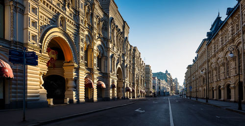 Street amidst buildings against sky in city