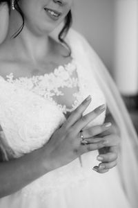 Midsection of bride wearing ring in finger