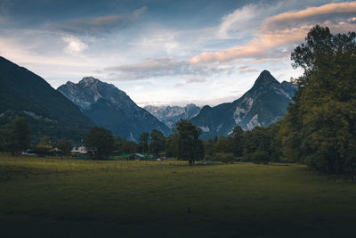 Scenic view of field and mountains against sky