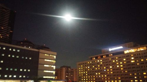 Low angle view of buildings against sky at night