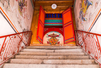 Stairs leading to a painted door of a tibetan prayer hall at kumbum near xining, china