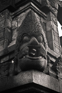 Low angle view of statue against historic building