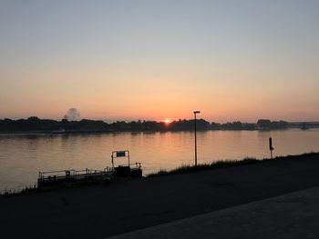 Scenic view of river against sky during sunset