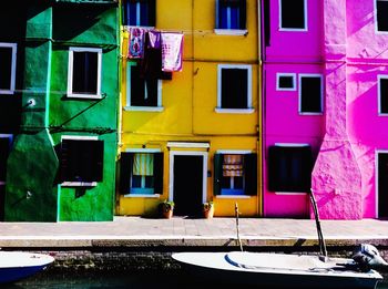 Multi colored buildings against blue sky