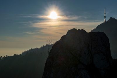 Scenic view of silhouette mountains against sky during sunset