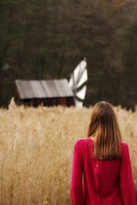 Rear view of woman standing on field