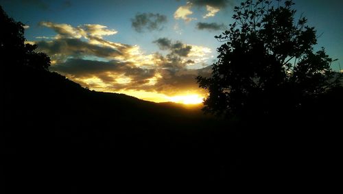 Scenic view of silhouette landscape against sky at sunset