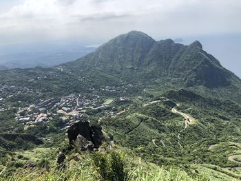 Aerial view of land and mountains against sky