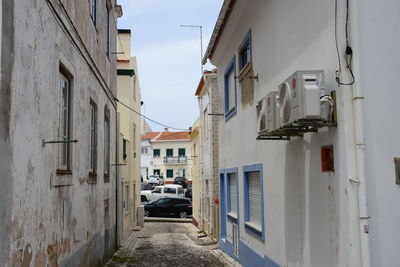 Narrow street amidst buildings in city