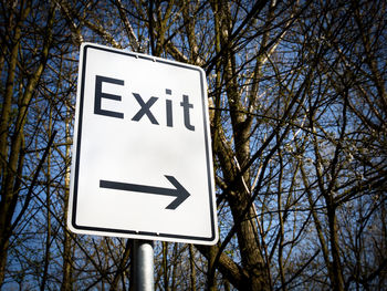 Low angle view of road sign against sky