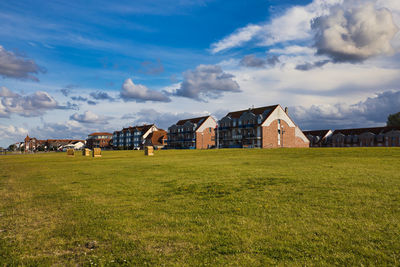 Houses on field against sky