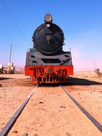 Rear view of train on railroad track against sky