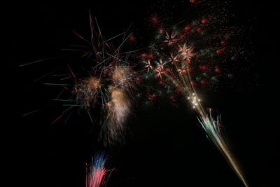 Low angle view of firework display against sky at night