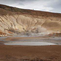 View of desert against cloudy sky