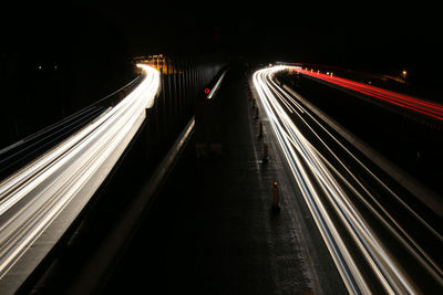 Light trails on road in city at night