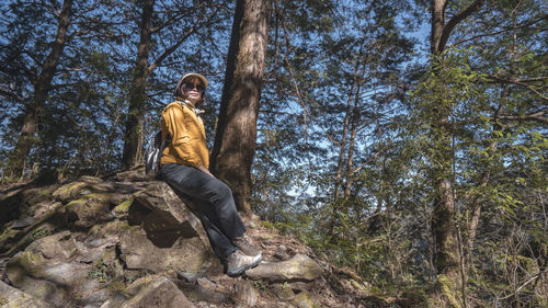 Portrait of young man standing in forest