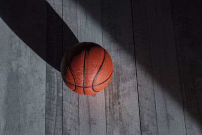 High angle view of basketball on hardwood floor