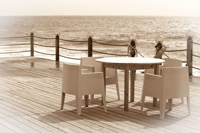 Chairs on beach against sea