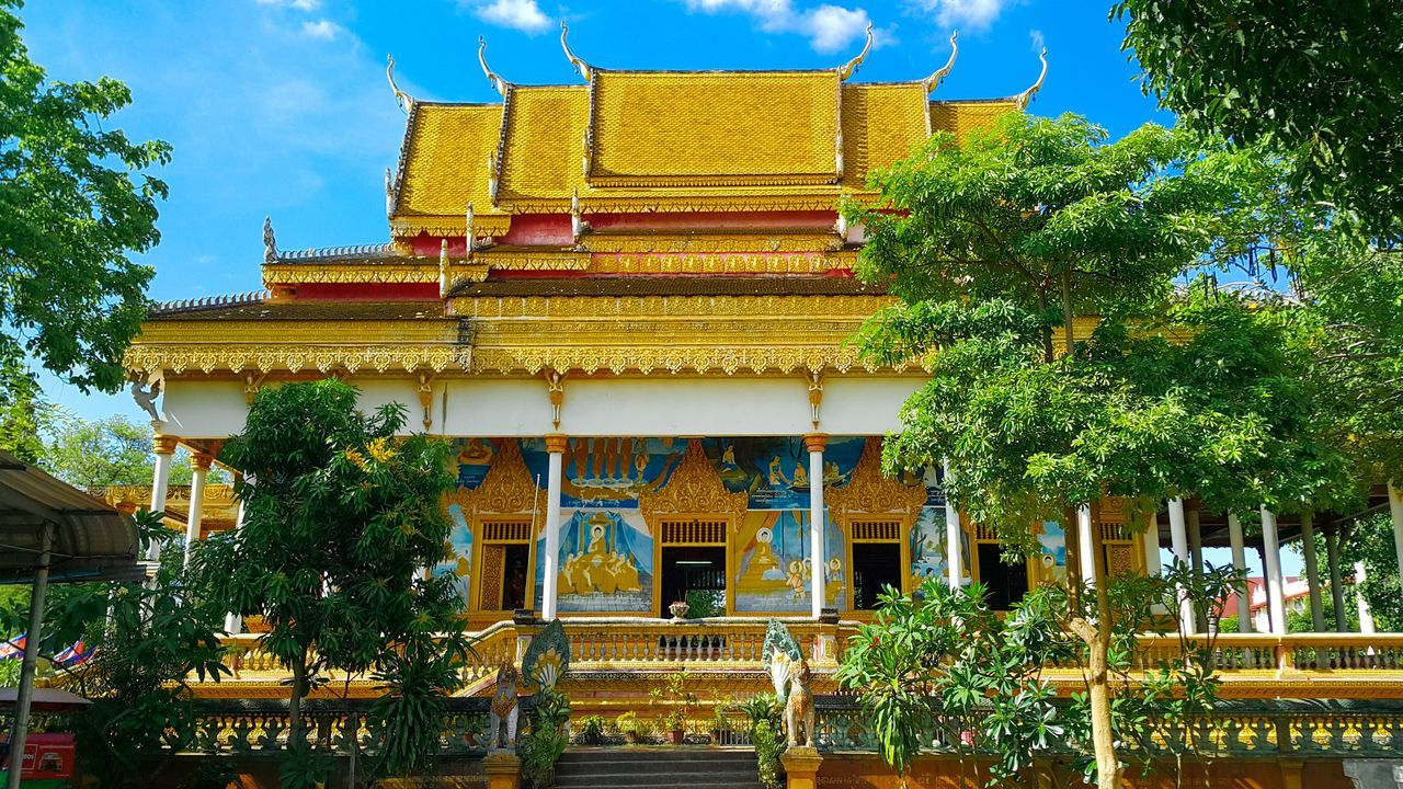 religion, architecture, spirituality, building exterior, place of worship, tree, built structure, pagoda, gold colored, outdoors, sky, no people, gold, travel destinations, low angle view, day, statue