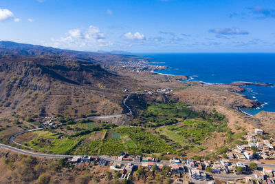 High angle view of buildings by sea against sky