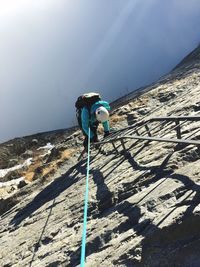 Man standing on mountain against sky