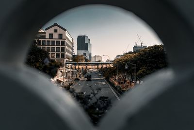 Surface level of road amidst buildings against sky