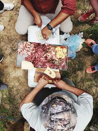 Low section of people holding food