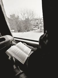 Close-up of hand on open book