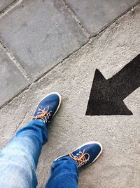 Low section of man standing on tiled floor