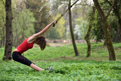 Mid adult woman exercising at public park