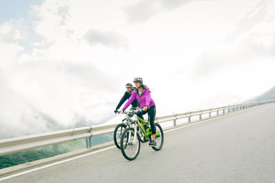 Man riding bicycle on road