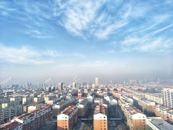 High angle view of buildings in city against sky