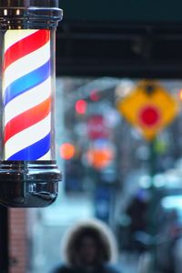 Close-up of multi colored barber shop pole lights on new york city