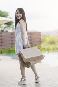 Full length portrait of woman standing outdoors