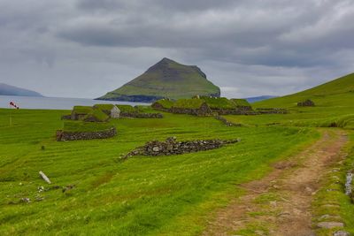 Scenic view of green landscape against sky